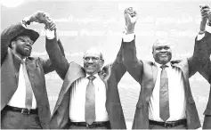  ??  ?? Kiir (left), Bashir (centre) and Machar hold hands after signing a peace agreement aimed to end a war in which tens of thousands of people have been killed, in Khartoum, Sudan. — Reuters photo