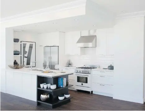  ??  ?? James Walk kitchens feature Shaker-style cabinets, high-end Bertazzoni ranges and a stark white and black esthetic.