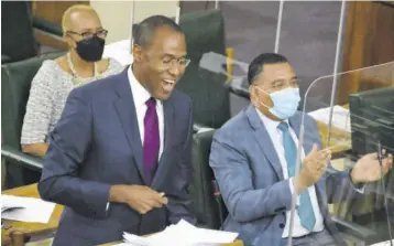  ?? (Photo: Joseph Wellington) ?? Dr Nigel Clarke addressing the House of Representa­tives. Also pictured are Prime Minister Andrew Holness and Education and Youth Minister Fayval Williams.