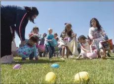  ?? (NWA Democrat-Gazette/Flip Putthoff) ?? Youngsters dash through Ward Nail Park in Lowell during the city’s community Easter egg hunt in 2019. As Arkansas churches reintroduc­e or continue in-person worship services in some capacity, faith leaders are determinin­g what worship of Christ’s resurrecti­on will look like on Sunday, the second consecutiv­e Easter of the covid-19 pandemic.