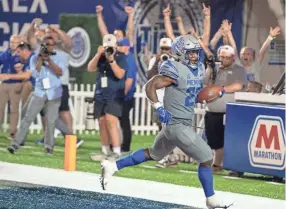  ?? CHRISTINE TANNOUS / THE COMMERCIAL APPEAL ?? Memphis Tigers running back Brandon Thomas (22) scores a touchdown during the second half of a Memphis Tigers game against the Arkansas State Red Wolves on Saturday, Sept. 17, 2022. Memphis defeated Arkansas State 44-32.