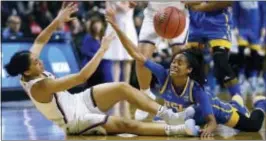  ?? JESSICA HILL — THE ASSOCIATED PRESS ?? Connecticu­t’s Gabby Williams, left, and UCLA’s Jordin Canada scramble on the floor for a loose ball Saturday in Bridgeport, Conn.