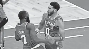  ?? BRIAN FLUHARTY / USA TODAY SPORTS ?? Celtics forward Jayson Tatum, right, celebrates with guard Jaylen Brown after scoring against the Bucks during the second half