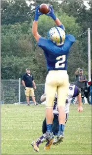  ?? Photo by Mike Eckels ?? Decatur’s Cayden Bingham (2) catches a high pass from quarterbac­k Joseph Armstrong during the Decatur-Berryville game at Bulldog Stadium on Sept. 1. Bingham gained 5 yards on the play.