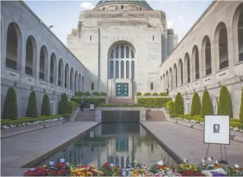  ?? Australian War Memorial ?? The Roll of Honour at the Australian War Memorial decorated with poppies (left) and the pool of reflection (right).