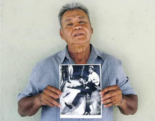  ?? JUD ESTY-KENDALL / STORYCORPS VIA AP ?? Juan Romero holds a Los Angeles Times photograph that shows him with Sen. Robert F. Kennedy moments after Kennedy was shot at the Ambassador Hotel in Los Angeles in 1968. Romero died Monday at age 68.