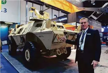  ?? Abdul Rahman/Gulf News ?? Christophe­r G. Smith, Programe Director, Internatio­nal vehicles, Marine and Land Systems of Textron Systems, showing a Commando Select armoured vehicle at yesterday.