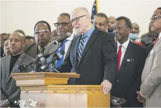  ?? ASHLEE REZIN/SUN-TIMES ?? Mayoral candidate CEO Paul Vallas accepts the endorsemen­ts of Willie Wilson (behind Vallas, in red tie) and faith leaders on Sunday at Providence Missionary Baptist Church.