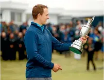  ?? PHOTO: GETTY IMAGES ?? Jordan Spieth admires the Claret Jug after becoming just the second player since Jack Nicklaus to win three different majors before the age of 24, something not even Tiger Woods achieved.