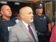  ??  ?? Troy Mayor Patrick Madden comes outside of Troy City Hall with some police officers to address the media and protesters after meeting with the shooting victims family Wednesday afternoon.