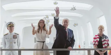  ?? APPHOTO ?? MOVING EXPERIENCE: President Trump, center right, and first lady Melania Trump, center left, accompanie­d by Pacific Command commander Adm. Harry Harris and his wife, Bruni Bradley, throw flower petals while visiting the USS Arizona Memorial in Honolulu...