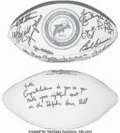  ?? AUCTIONS /COURTESY HERITAGE ?? 1972 Miami Dolphins team-signed reunion football and Stephen Ross-signed football to Jake Scott.