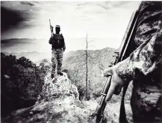  ?? Nick Quested/National Geographic Documentar­y Films ?? A masked narco stands atop a rock in the Sinaloa mountains in the documentar­y ‘Blood on the Wall.’ —