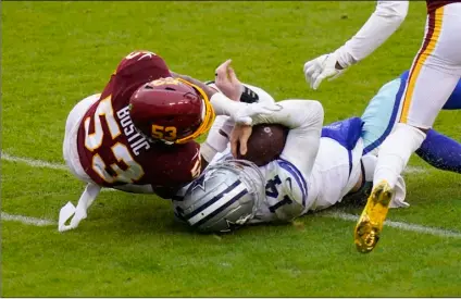  ?? AP Photo/Patrick Semansky ?? Dallas Cowboys quarterbac­k Andy Dalton (14) collides with Washington Football Team inside linebacker Jon Bostic (53) in the second half of an NFL football game, on Sunday in Landover, Md. Dalton left the field after this hit.