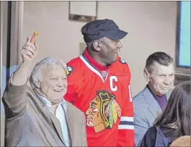  ??  ?? Blackhawks legends Bobby Hull and Stan Mikita flank absentee Bobcats owner Michael Jordan on Monday at the United Center. | TOM CRUZE~SUN-TIMES