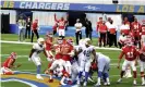  ?? Photograph: Keith Birmingham/AP ?? The Chargers and Chiefs watch as Harrison Butker’s winning kick takes flight.