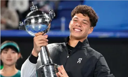  ?? Photograph: Shuji Kajiyama/AP ?? Ben Shelton of the United States holds the trophy after defeating Aslan Karatsev of Russia during the Japan Open men’s singles final on Sunday in Tokyo.