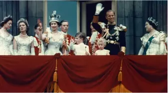  ??  ?? Waving to the crowds on the balcony at Buckingham Palace after the Coronation, 2 June 1953