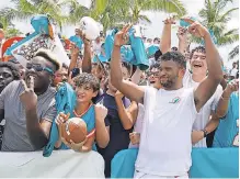  ?? MARTA LAVANDIER/ AP ?? Dolphins quarterbac­k Tua Tagovailoa takes a photo with fans after practice Tuesday in Miami Gardens.