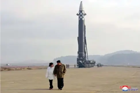  ?? (EPA) ?? K im Jong - un with his daughter at the l aunch site of a l ong - range ba ll istic weapon, the first she has been officia ll y seen in pub l ic