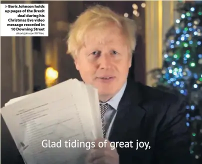  ?? @borisjohns­on/PA Wire ?? > Boris Johnson holds up pages of the Brexit deal during his Christmas Eve video message recorded in 10 Downing Street