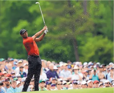  ?? DAVID J. PHILLIP/ASSOCIATED PRESS ?? Tiger Woods hits on the 12th hole during the final round of the Masters on April 14. Woods leaned on experience over shots like this to help him win the Masters for the fifth time.