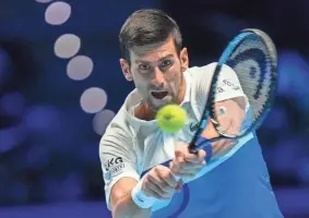  ?? ?? Novak Djokovic hits a return to Cameron Norrie during their ATP World Tour Finals singles match on Nov. 19.