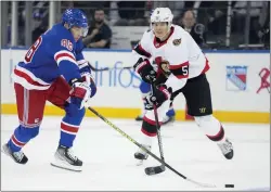  ?? JOHN MINCHILLO — THE ASSOCIATED ?? The Rangers’ Patrick Kane, left, skates the puck past Ottawa’s Nick Holden during the first period on Thursday at Madison Square Garden.