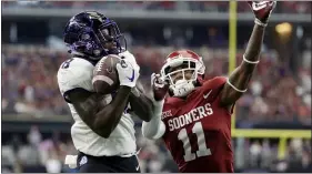  ?? TONY GUTIERREZ — THE ASSOCIATED PRESS ?? TCU wide receiver Jalen Reagor, here hauling in a touchdown over Oklahoma cornerback Parnell Motley in the 2017 Big 12 championsh­ip game, will start life with the Eagles as DeSean Jackson’s backup and heir apparent, Doug Pederson said Tuesday.