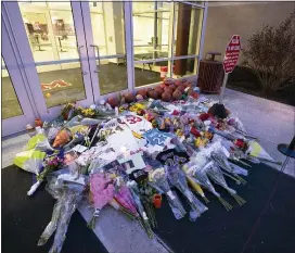  ?? CHRIS SZAGOLA — THE ASSOCIATED PRESS ?? Flowers, jerseys and imagery is left in remembranc­e to Kobe Bryant at a small memorial at the entrance of the Bryant Gymnasium at Lower Merion High School, Monday in Wynnewood, Pa.