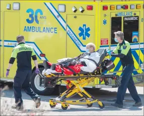  ?? Canadian Press photo ?? A patient is brought to the emergency department at Verdun Hospital Thursday in Montreal.