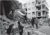  ?? GHAITH ALSAYED AP ?? People remove furniture and appliances from a collapsed building in Jinderis, Syria, on Tuesday.