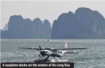  ?? ?? A seaplane docks on the waters of Ha Long Bay.