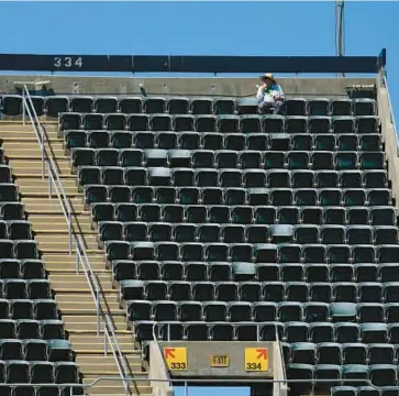  ?? JEFF CHIU/AP ?? A fan watches from the upper deck at RingCentra­l Coliseum during an A’s game Thursday in Oakland, California.