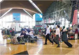  ??  ?? Passengers waiting for their flights at the Kuala Lumpur Internatio­nal Airport.