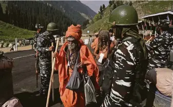  ?? Associated Press ?? Soldiers are deployed to guard Hindu devotees as they make an annual pilgrimage to an icy Himalayan cave in Kashmir. Officials say pilgrims face attacks from rebels fighting Indian rule.