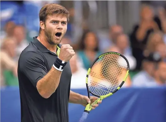  ?? JIM WEBER, THE COMMERCIAL APPEAL ?? Ryan Harrison reacts after scoring against Nikoloz Basilashvi­li in the singles championsh­ip at the Memphis Open Sunday. Harrison went on to win in straight sets against Basilashvi­li to win his first ATP championsh­ip.