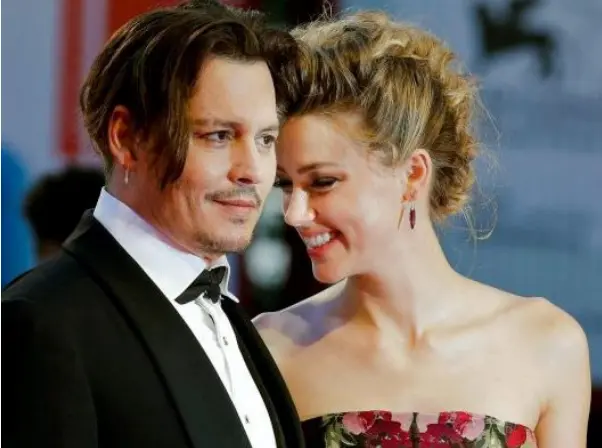  ??  ?? HAPPIER TIMES: Amber Heard and Johnny Depp at the Venice Film Festival last September. She has donated all of last week’s $7m divorce settlement to charity