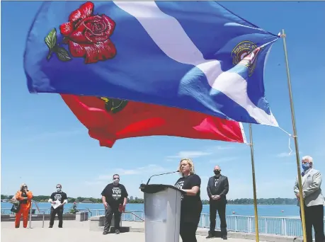  ?? PHOTOS: DAN JANISSE ?? Windsor and Ontario flags fly in the foreground as Lisa Macleod, Ontario minister of heritage, sport, tourism and culture, speaks during a Monday news conference at Coventry Gardens, where she announced funding to boost local tourism.