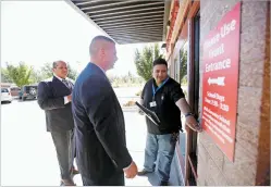  ?? LUIS SÁNCHEZ SATURNO/THE NEW MEXICAN ?? From left, Mario Salbidrez, Santa Fe Public Schools safety and security director; Mark Lewandowsk­i, SFPS emergency manager; and Ray Apodaca with ENGIE Services U.S., examine a gym door last week at Gonzales Community School. ENGIE Services U.S will install an access control card reader for the door.