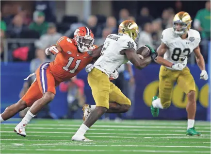  ?? TIM HEITMAN/USA TODAY SPORTS ?? Clemson linebacker Isaiah Simmons tackles Notre Dame running back Dexter Williams during the 2018 Cotton Bowl.