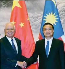  ??  ?? Najib shaking hands with Li during an official welcoming ceremony at the Great Hall of the People in Beijing.