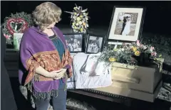  ?? AP ?? A woman attends a wake for victims of a drug cartel ambush that left three women and six children dead in La Mora, Mexico.