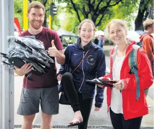  ?? PHOTOS: CHRISTINE O’CONNOR ?? The best things in life are free . . . Clockwise from above: Student Life member Cam Mackenzie (left) distribute­s jandals to students Claire Connors and Sophie Kirkman outside the university entrance; Otago Museum science communicat­or Nick Yeats creates a ‘‘storm in a bucket’’ for students (from left) Sarah Maskill, partly obscured, of Christchur­ch, John Commissari­s, of Auckland, Olivia Reiber, of Christchur­ch, and Sophie Tulley, of Timaru; Jessica Ford (left) and Miriam Jenkins offer free sanitary products; taking up the offer of free pizza are (from left) Ziyi Kok Mal (16), Indira Fernando (19), Tuseka Njoko (17) and Hanna Lin (17); New Zealand Blood Service southern donor recruitmen­t team leader Ali Keast shows off her wares at tent city.