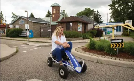  ?? VANESSA TIGNANELLI, RECORD STAFF ?? Fire safety educator Becky Moore takes a spin through Children’s Safety Village on Monday. It costs about $60,000 to run annually.