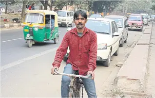  ??  ?? Waste collector Mohammad Khokun
Hamid makes his rounds in the neighbourh­ood near his
home in South Delhi.