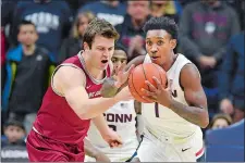  ?? STEPHEN DUNN/AP PHOTO ?? UConn’s Christian Vital, right, steals the ball from Saint Joseph’s guard Ryan Daly in the first half of Wednesday’s game at Storrs.