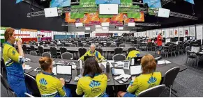  ?? — AFP ?? Full interest: Volunteers attending a briefing at the media centre ahead of the opening ceremony.