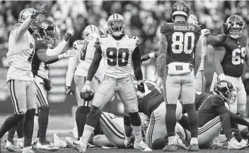  ?? Steve Luciano / Associated Press ?? Defensive end DeMarcus Lawrence (90) was at the center of the Cowboys’ dominant defensive performanc­e against the Giants, forcing a fumble and making two other big plays in Dallas’ 21-6 victory Sunday afternoon.