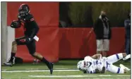  ?? (Arkansas Democrat-Gazette/Thomas Metthe) ?? Arkansas State University wide receiver Jonathan Adams Jr. (left) slips away from Georgia State safety Chris Bacon during the fourth quarter of the Red Wolves’ victory over the Panthers on Thursday at Centennial Bank Stadium in Jonesboro. Adams and teammate Dahu Green combined for 24 catches, 349 yards and 4 touchdowns in the victory.